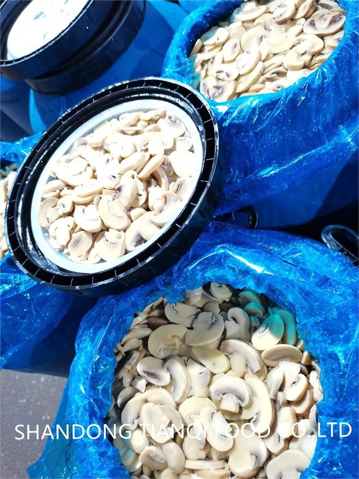 Salted sliced white mushroom in plastic drums